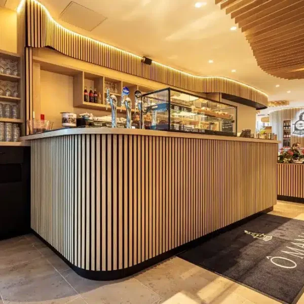 Bar de la brasserie et salle avec habillage bois aux murs et au plafond